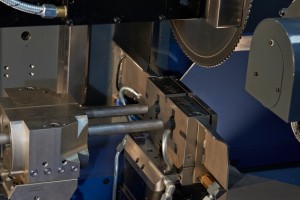 Close-up of twin cutting head; machine cuts two workpieces simultaneously 